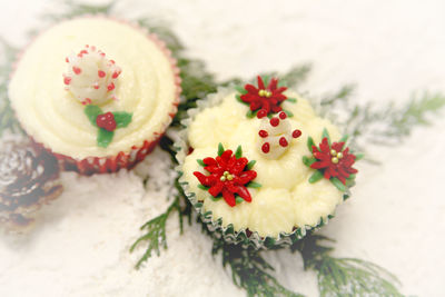 High angle view of christmas cupcakes with pine needles