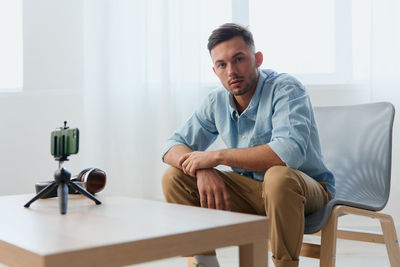 Portrait of senior man sitting at home