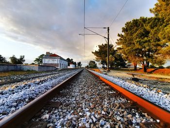 Surface level of railroad tracks against sky