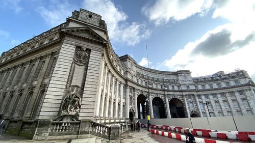 Low angle view of historical building against cloudy sky