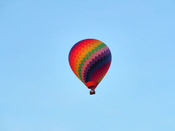 Low angle view of hot air balloon against clear blue sky