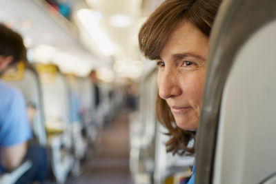 Mature woman on airplane seat