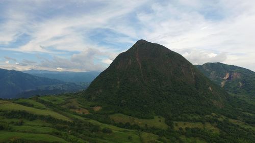 Scenic view of mountains against cloudy sky