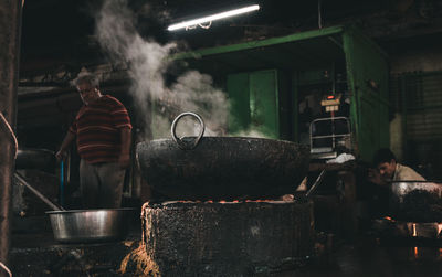 Man working on barbecue grill