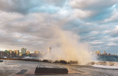 Panoramic view of sea and buildings against sky