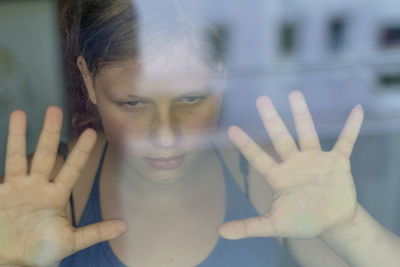 Teenage girl seen through glass window