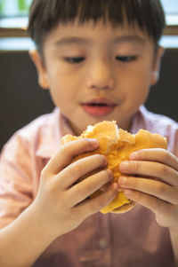 Close-up of boy eating burger