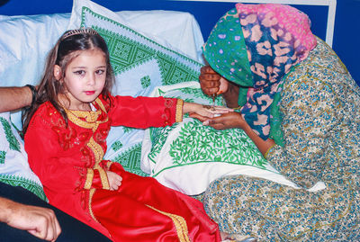 Portrait of girl getting heena tattoo on hand