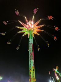 Low angle view of illuminated ferris wheel against sky at night