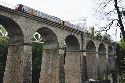 Low angle view of train passing on railway bridge