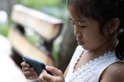 Midsection of woman using mobile phone outdoors