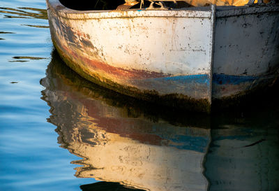Close-up of old boat in lake against sky