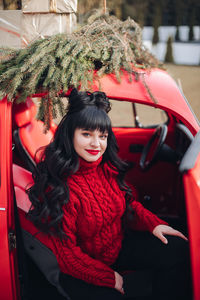 Portrait of young woman in car