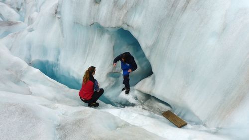 Rear view of women in snow