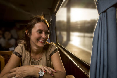 Smiling woman sitting by train window
