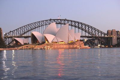 Bridge over river with city in background