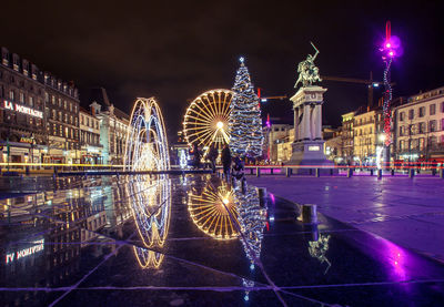 Illuminated buildings in city at night