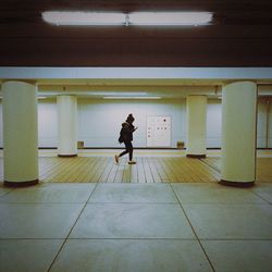 Full length of woman standing on wall