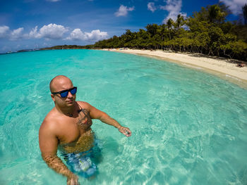 Man in swimming pool against sea