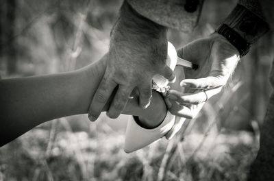 Midsection of couple holding hands