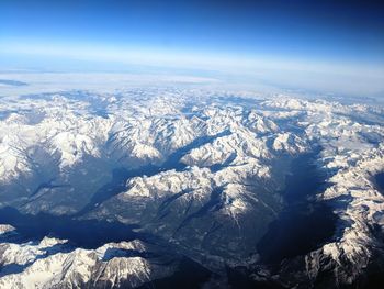 Aerial view of snowcapped mountains against sky