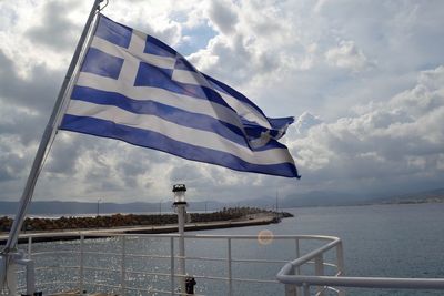 Flag on sea against sky