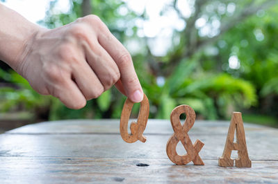 Close-up of hand holding food on table