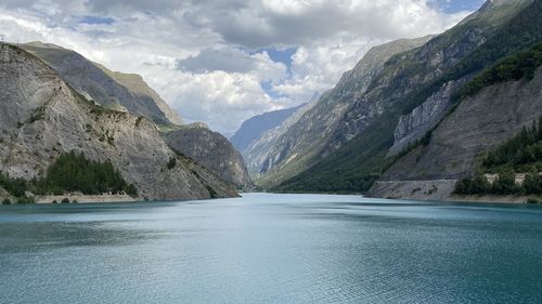 Scenic view of sea and mountains against sky