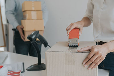 Midsection of woman working in box