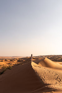 Scenic view of beach against clear sky during sunset