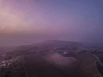 High angle view of buildings in city during sunset