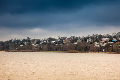 Beautiful houses and beaches on the banks of elbe river in hamburg on a cold end of winter day