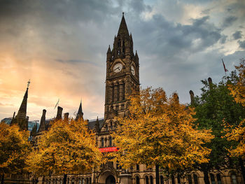 Low angle view of manchester town hall at autumn