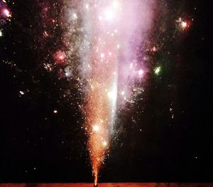 Low angle view of firework display at night