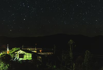 Scenic view of silhouette mountain against sky at night