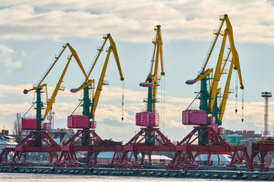 Massive harbor cranes in seaport. heavy load dockside cranes in port, cargo container yard