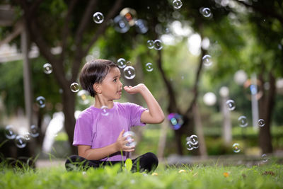 Young woman blowing bubbles