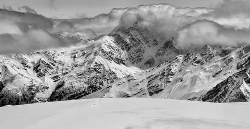 Scenic view of snow covered mountains against sky