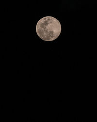 Low angle view of moon against dark sky