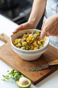 Woman seasoning food with salt