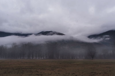 Scenic view of mountains against cloudy sky