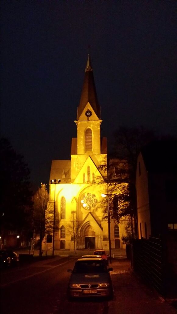 building exterior, architecture, illuminated, night, built structure, religion, church, street, place of worship, road, spirituality, the way forward, transportation, tree, sky, outdoors, street light, car