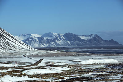 Ring road in iceland in wintertime with volcano mountain landscape in background