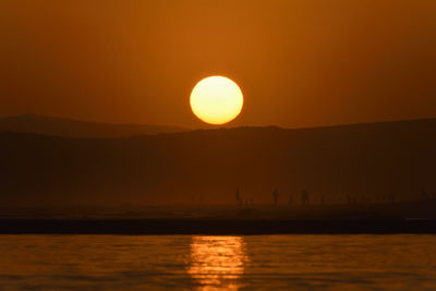 Scenic view of sea against orange sky