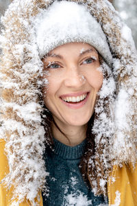 Portrait of a smiling woman in snow