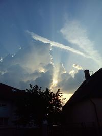 Low angle view of house against cloudy sky