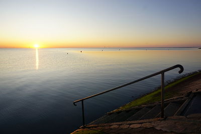 Scenic view of sea against clear sky during sunset