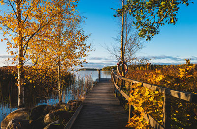 Pier over lake against sky during autumn