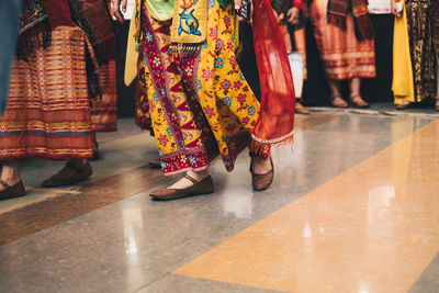 Low section of people standing on street