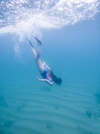 Full length of woman diving undersea